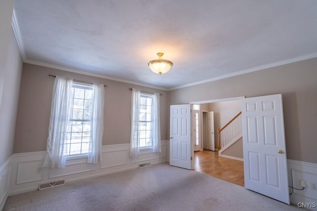 carpeted empty room with crown molding