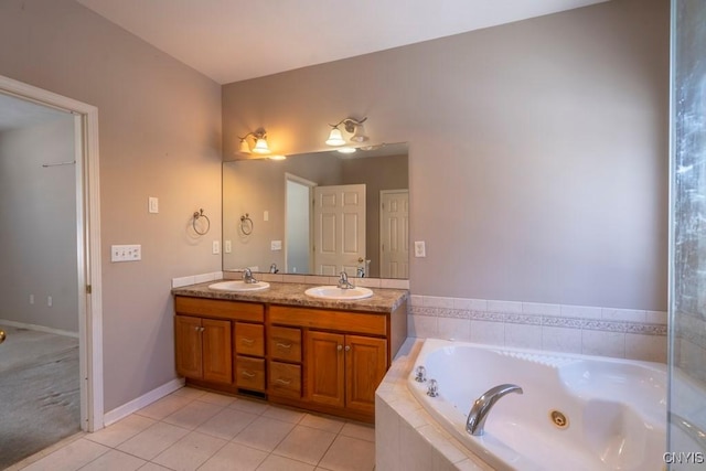 bathroom featuring vanity, tile patterned flooring, and tiled tub