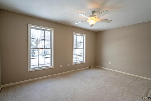 empty room with light colored carpet and ceiling fan