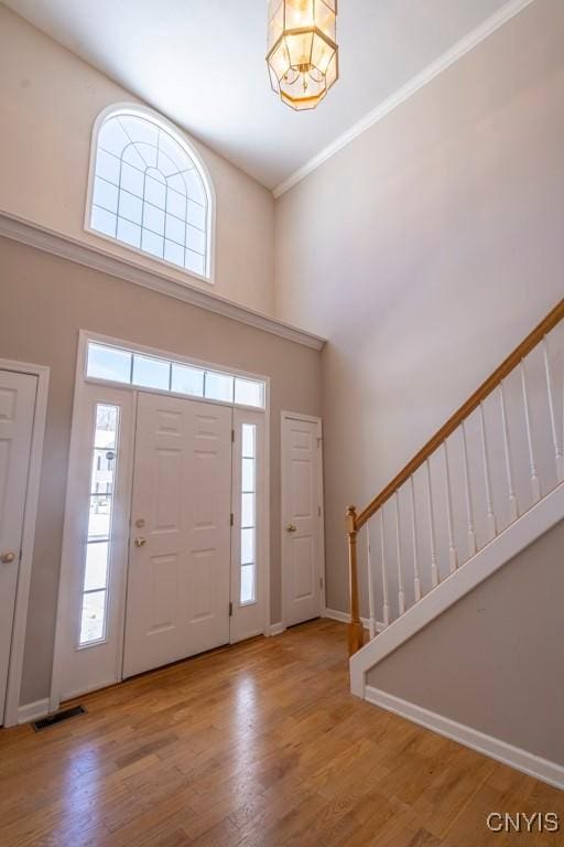 foyer featuring hardwood / wood-style flooring and a high ceiling