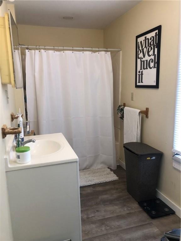 bathroom with vanity, wood-type flooring, and walk in shower