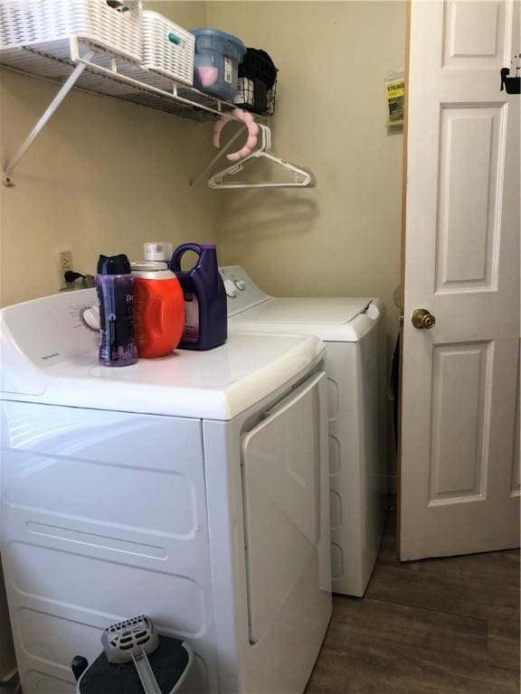 laundry area with dark wood-type flooring and independent washer and dryer