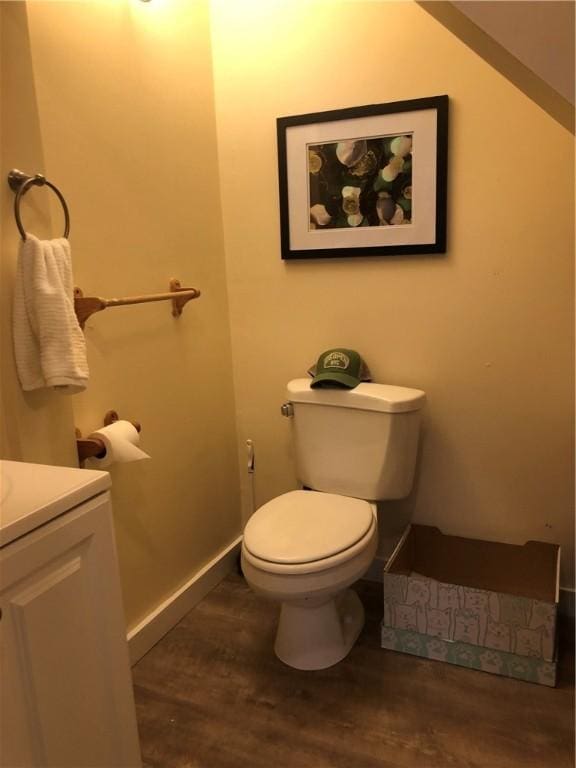 bathroom with vanity, hardwood / wood-style floors, and toilet