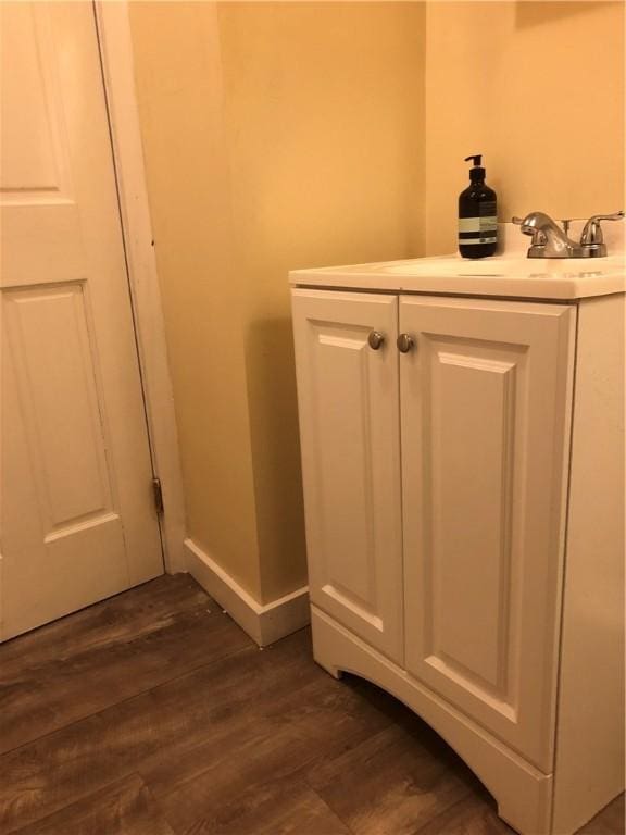 details featuring hardwood / wood-style flooring and vanity