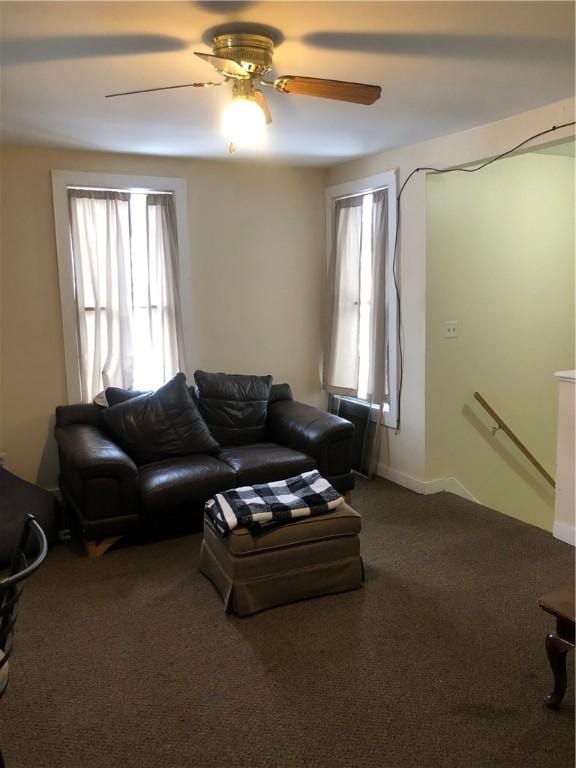 living room with ceiling fan and carpet flooring