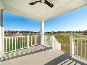 view of patio featuring ceiling fan, a porch, and a rural view