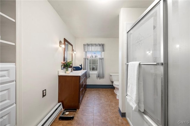 bathroom featuring tile patterned floors, toilet, a shower with shower door, a baseboard radiator, and vanity