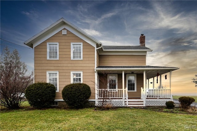 view of front of home with a yard and covered porch