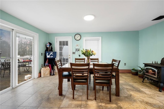 dining room with a wood stove