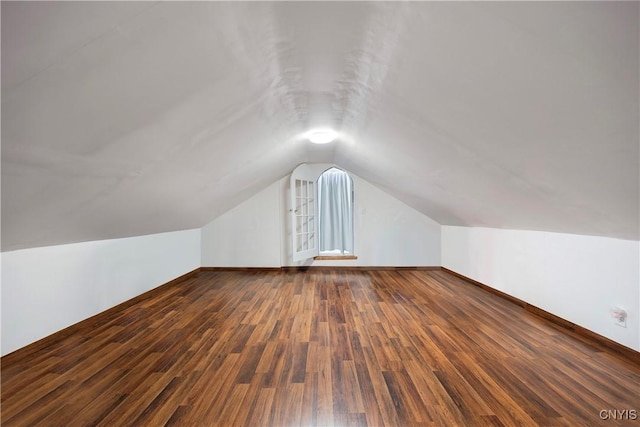 additional living space with lofted ceiling and dark hardwood / wood-style floors