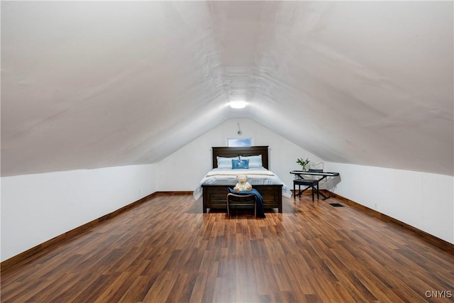 interior space featuring vaulted ceiling and dark hardwood / wood-style floors