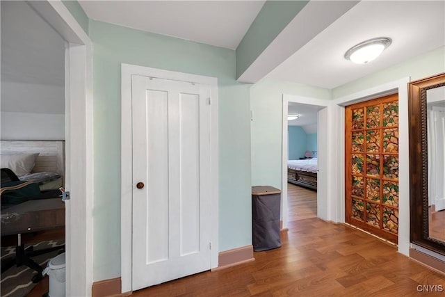 hallway with hardwood / wood-style flooring