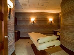 interior space featuring tile patterned flooring and wood walls