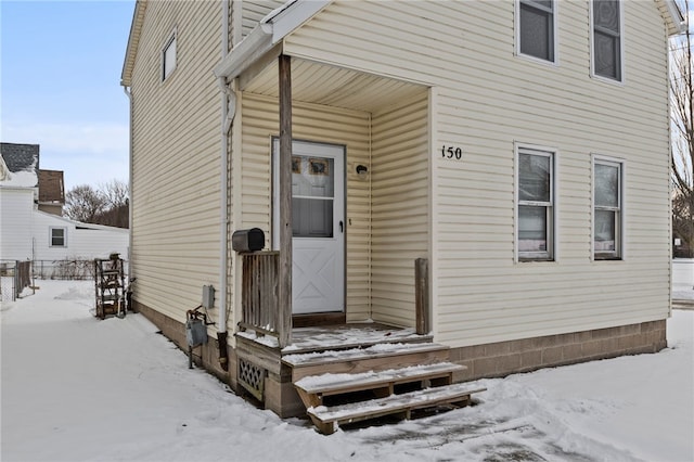 view of snow covered property entrance