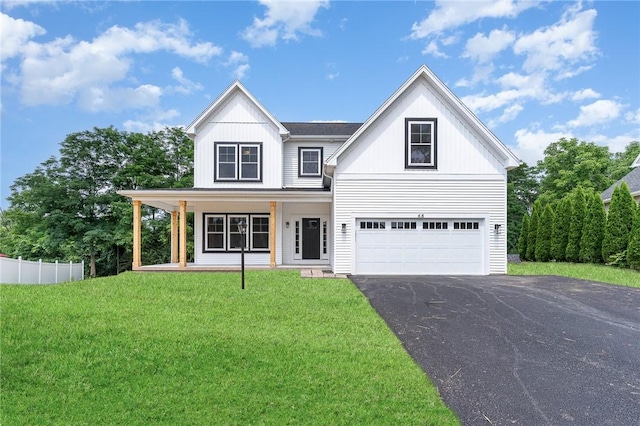 view of front facade featuring a porch, a garage, and a front yard