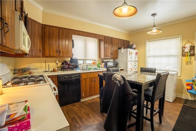 kitchen featuring sink, crown molding, white appliances, hanging light fixtures, and dark hardwood / wood-style flooring