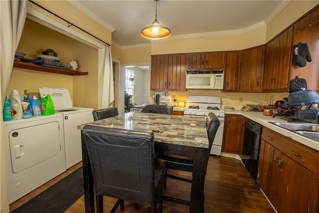 kitchen with washer and dryer, pendant lighting, dark hardwood / wood-style flooring, a center island, and white appliances