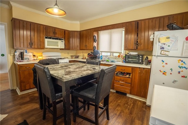 kitchen with crown molding, white appliances, and dark hardwood / wood-style floors