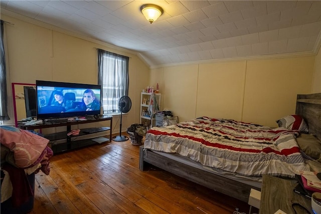 bedroom featuring hardwood / wood-style flooring and vaulted ceiling