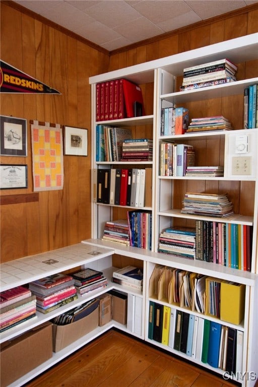 unfurnished room featuring hardwood / wood-style floors and wood walls