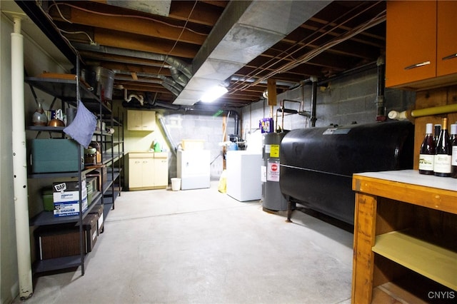 basement featuring separate washer and dryer and water heater