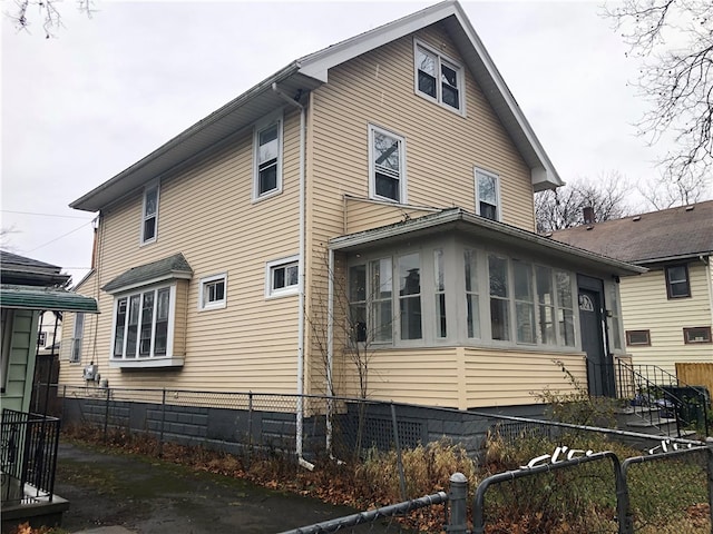 view of home's exterior with a sunroom