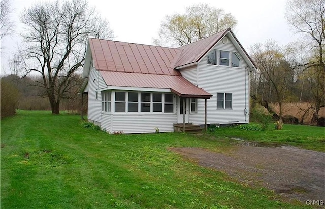 back of property with a lawn