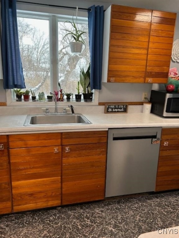 kitchen featuring stainless steel appliances, sink, and a wealth of natural light