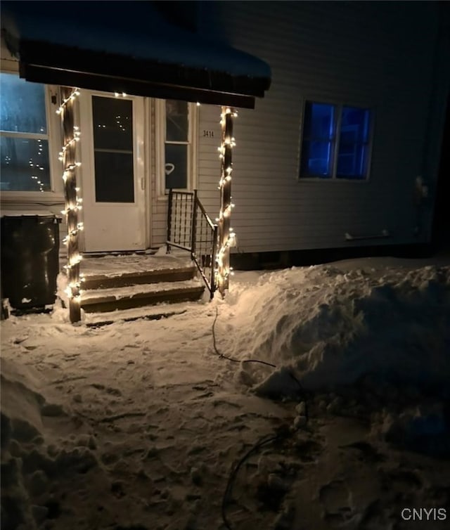 view of exterior entry at night