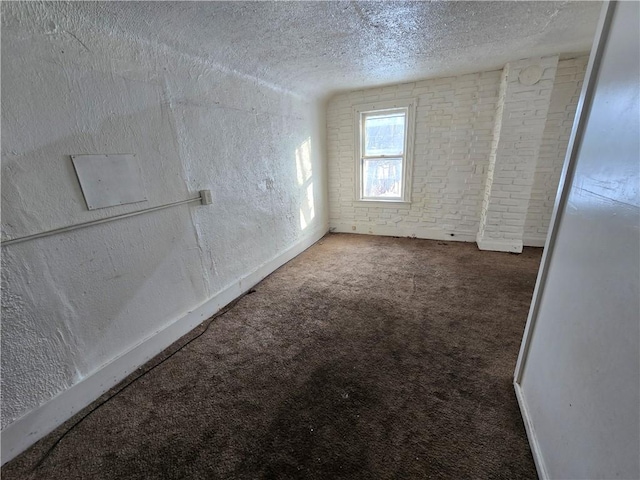 carpeted spare room featuring a textured ceiling