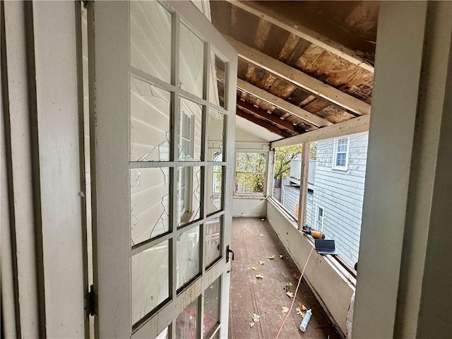 unfurnished sunroom with lofted ceiling with beams and wooden ceiling