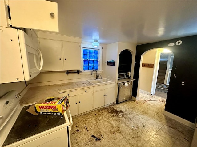 kitchen with sink, white cabinets, and white appliances