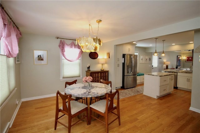 dining room featuring an inviting chandelier and light wood-type flooring