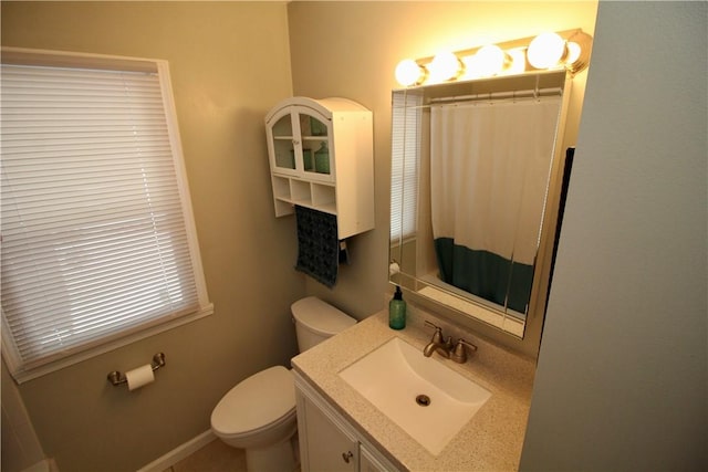 bathroom with vanity, toilet, and a shower with shower curtain