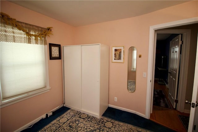 unfurnished bedroom featuring multiple windows and a closet