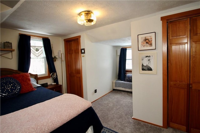 carpeted bedroom featuring a textured ceiling