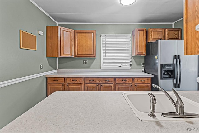 kitchen featuring stainless steel fridge and sink