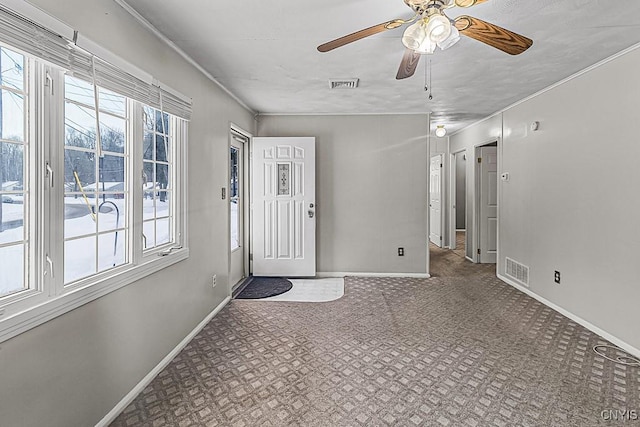 carpeted entryway featuring ceiling fan