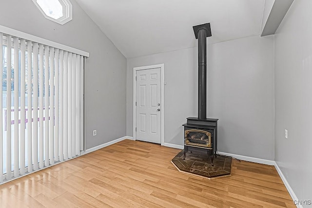 unfurnished living room featuring light hardwood / wood-style flooring and a wood stove