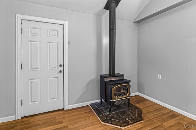 details featuring hardwood / wood-style floors and a wood stove