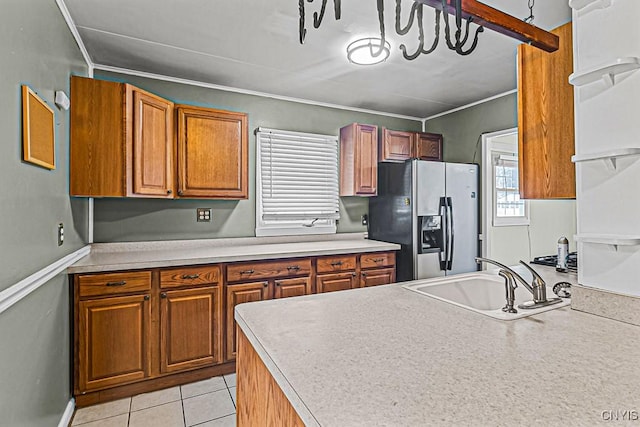 kitchen featuring sink, stainless steel fridge, and light tile patterned flooring