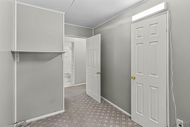 walk in closet featuring light carpet