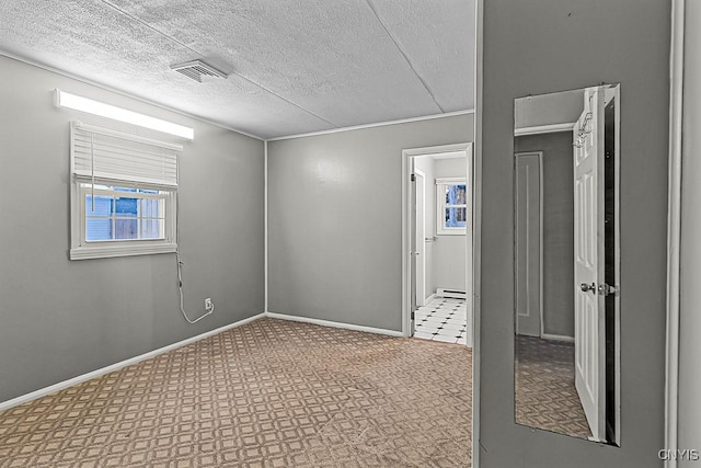 empty room featuring a textured ceiling