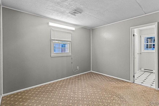 spare room with a textured ceiling and baseboard heating