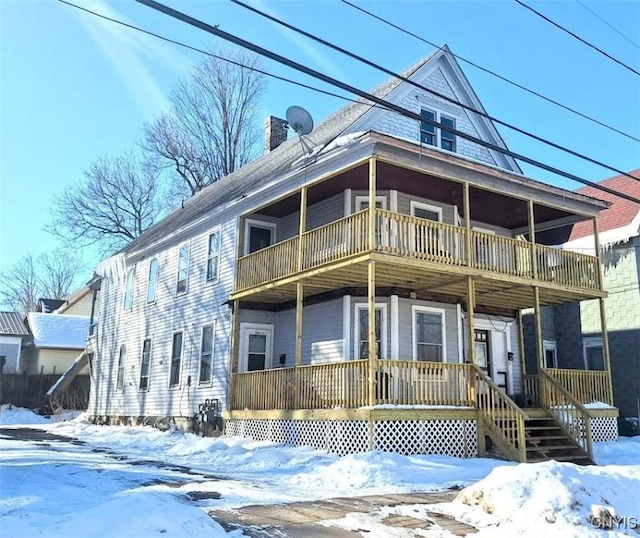 view of front of house featuring a balcony and covered porch