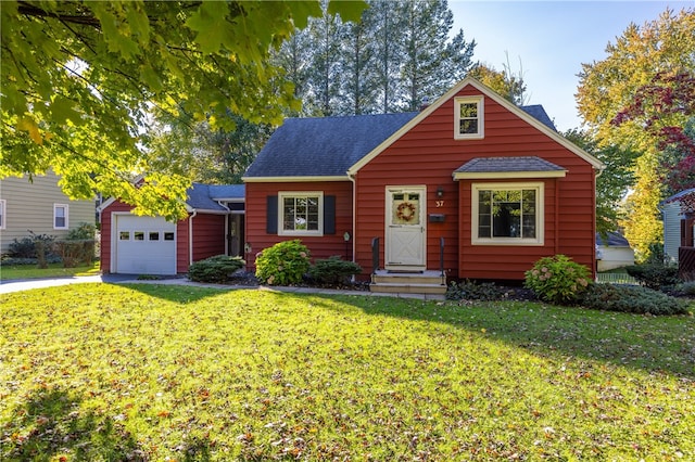 view of front facade with a garage and a front lawn