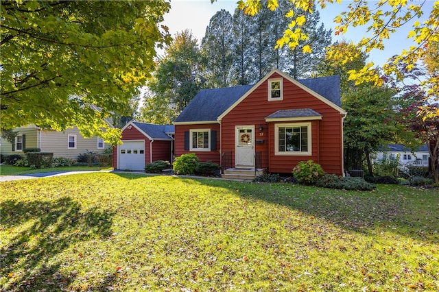 view of front of house with a garage and a front lawn