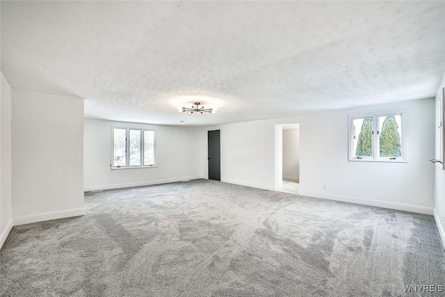 empty room featuring light carpet and a textured ceiling