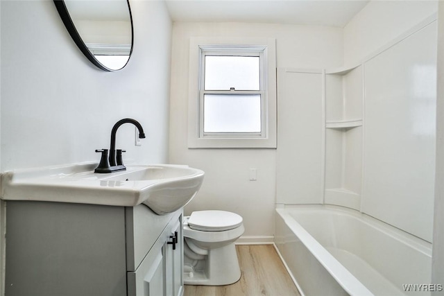 full bathroom featuring vanity, wood-type flooring, toilet, and washtub / shower combination