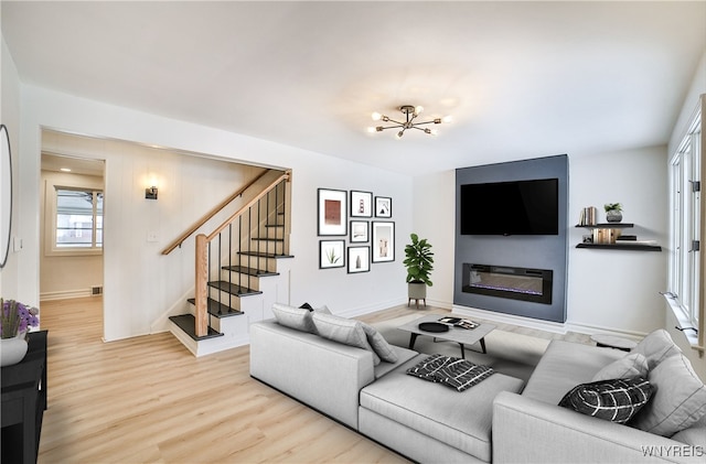 living room featuring a notable chandelier and light hardwood / wood-style flooring